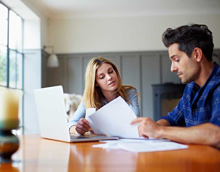 a couple going through some paperwork together at home